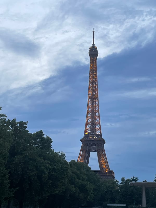 Eiffel Tower glows golden during evening illumination display
