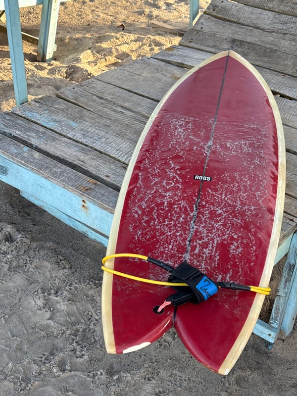 Red surfboard on a beach deck in Kathaluwa, Sri Lanka