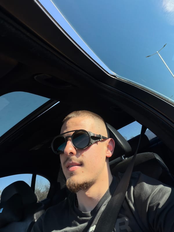 Man in sunglasses sits in car with sunroof, Plovdiv