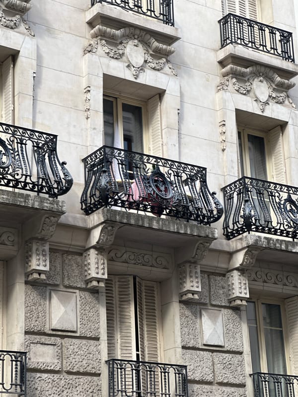 Close-up tour of Parisian building facades on a clear summer afternoon