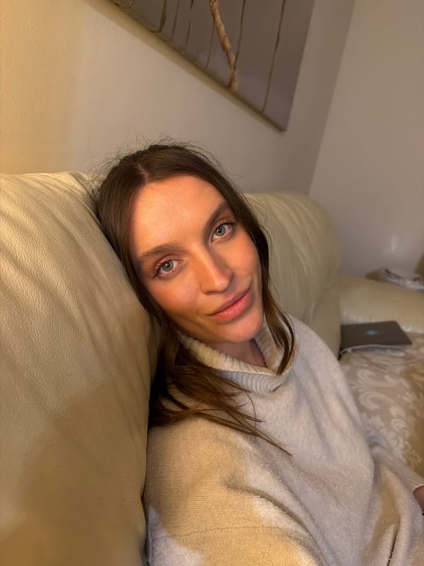 Woman rests on sofa indoors in Budva, Montenegro