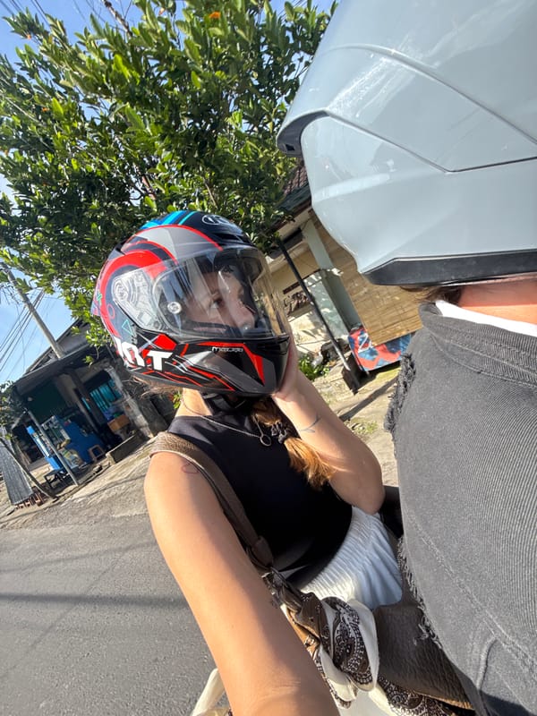 Motorcyclist travels through Blahbatuh village street during morning hours