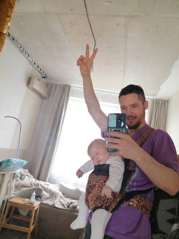 Man takes selfie with baby while making peace sign