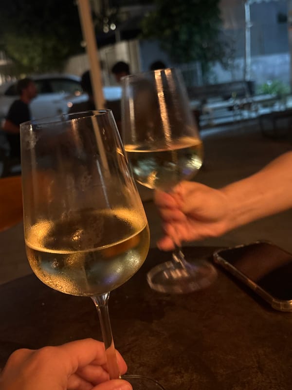 Evening wine and sidewalk moments captured in Tel Aviv