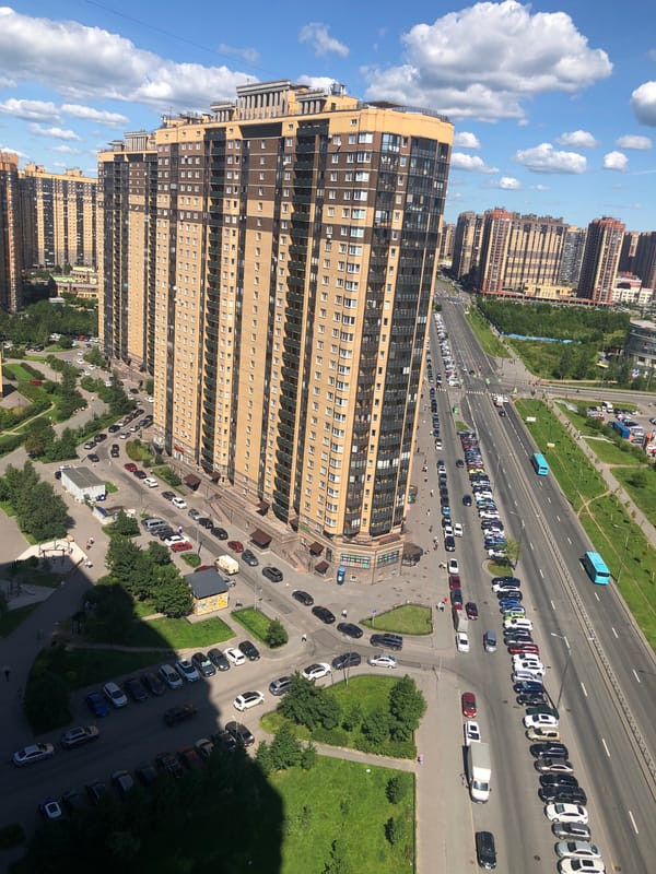 Drone pass over a mixed-use urban district on a sunny day