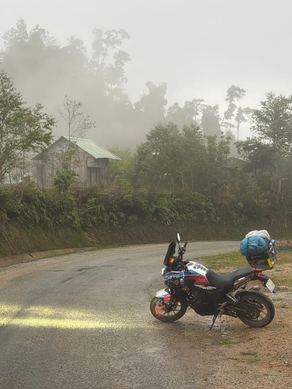 Loaded motorcycle spotted on foggy hillside road near Đà Nẵng