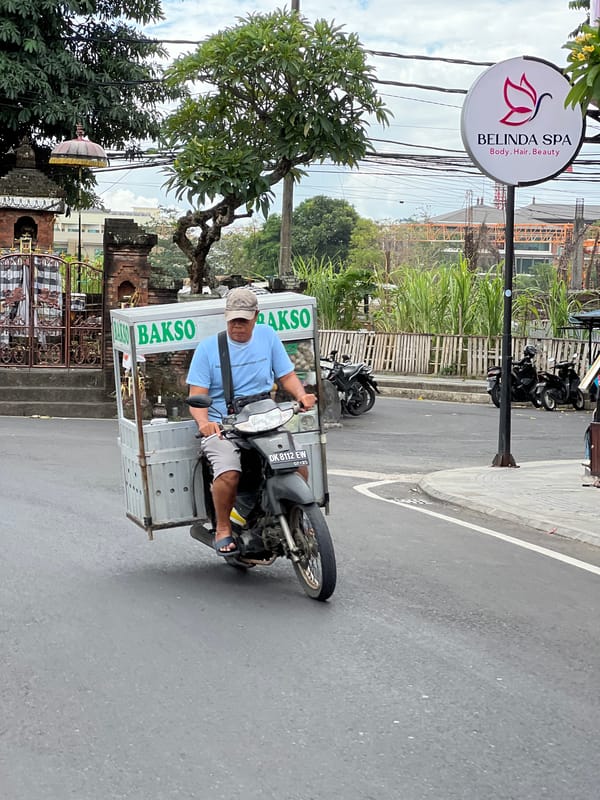 Denpasar streets alive with scooters, deliveries, and daily movement