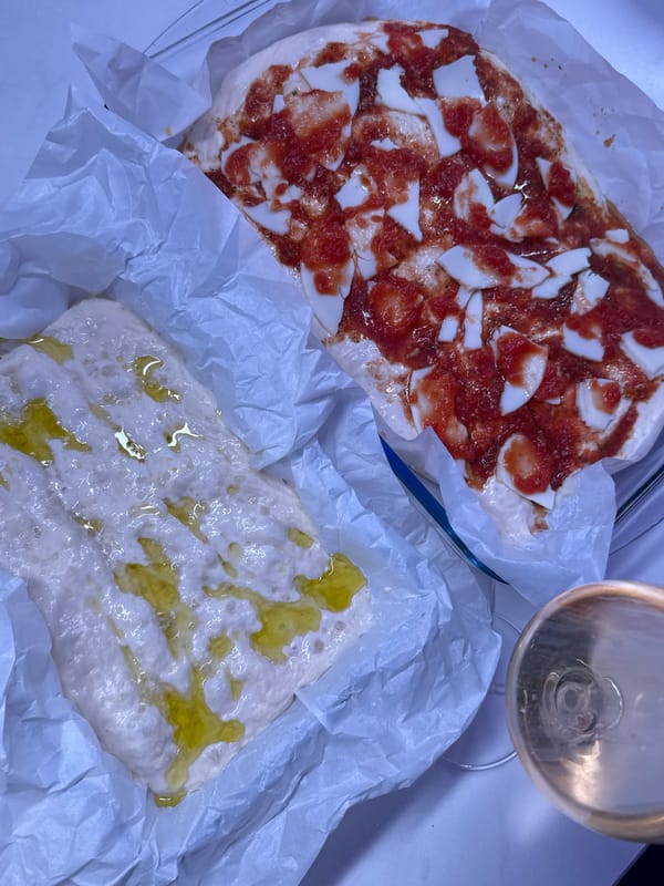 Woman prepares homemade pizza in Ariel kitchen afternoon