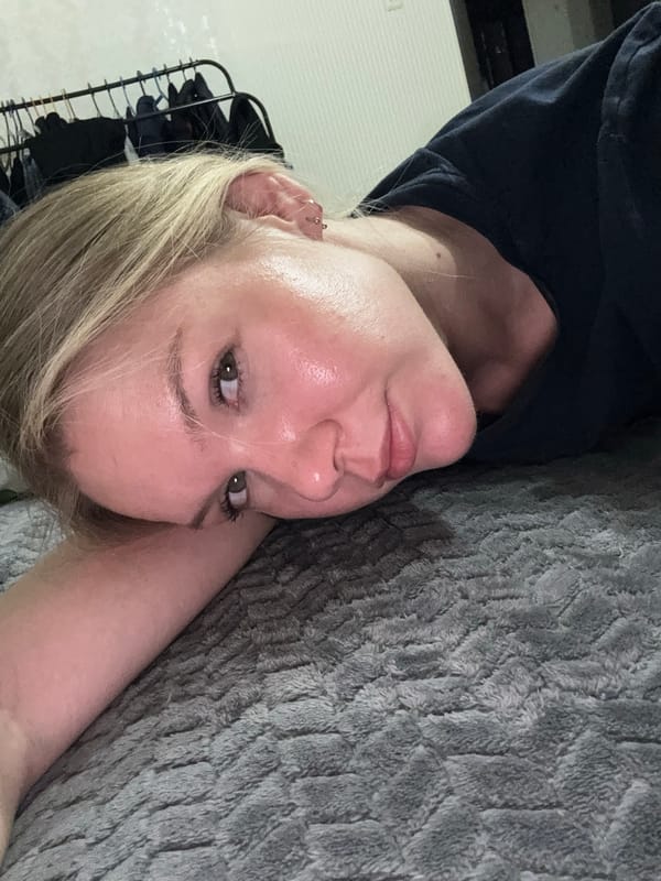Woman takes selfies while resting with cat in Perm