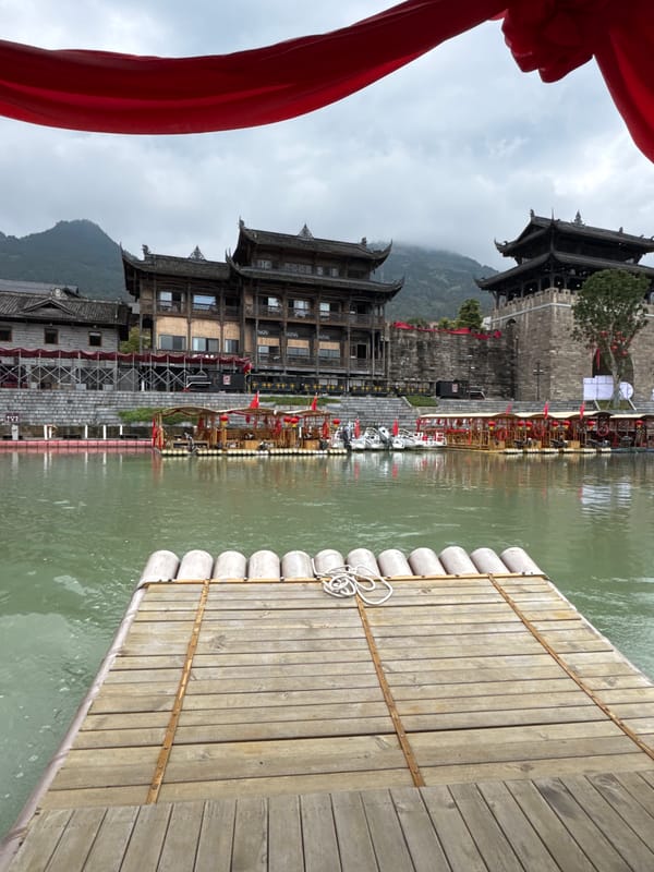 Tourist river rafting experience in traditional Chinese setting