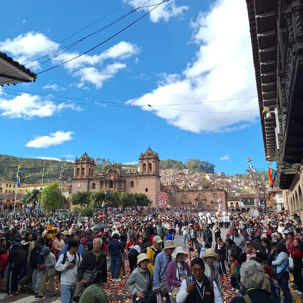 Festive crowd dances in historic Cuzco square