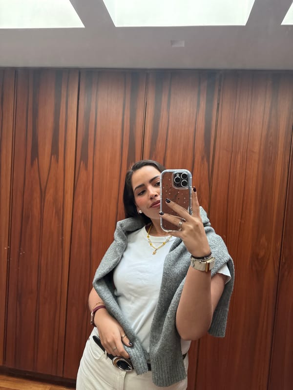 Woman poses for photos with laptop on marble stairs