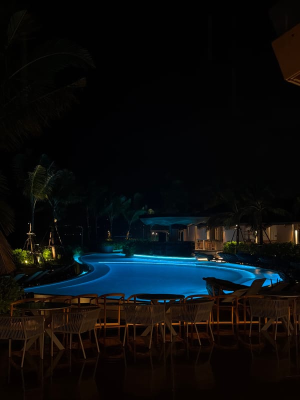 Illuminated pool scene captured at night in Choeng Thale