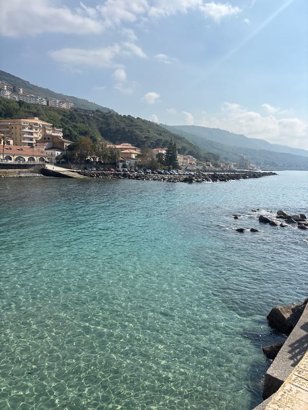 Beachgoers enjoy clear waters at Pizzo, Italy coastline