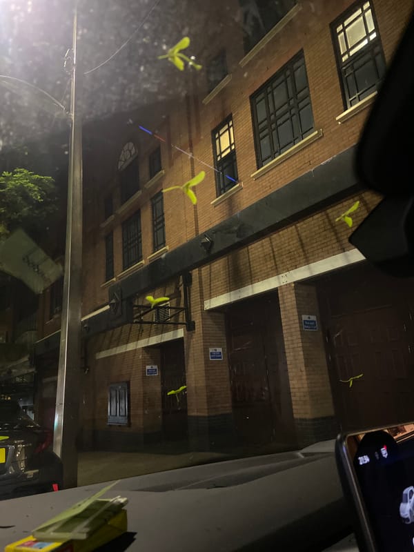 Nighttime photo of brick building captured from vehicle in Bristol