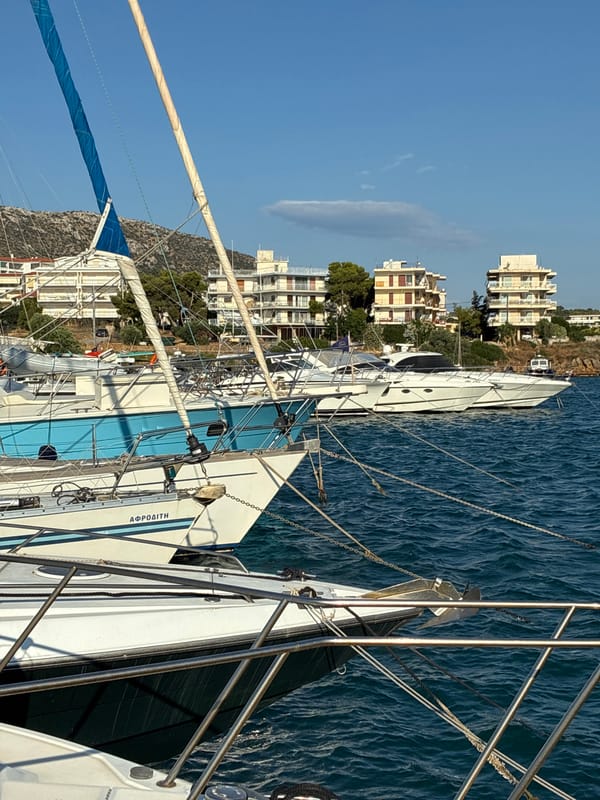 Quiet morning at Limenas Markopoulou harbor, boats moored in calm water