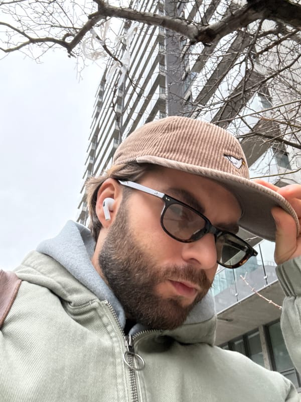 Man in embroidered cap observed on Montreal sidewalk