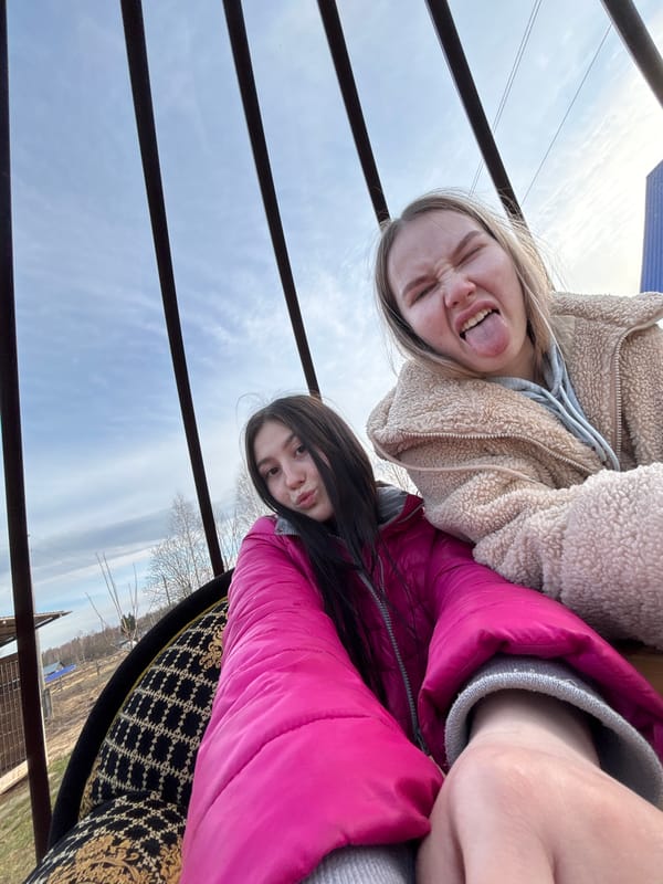 Young women take playful selfies outdoors in Russia