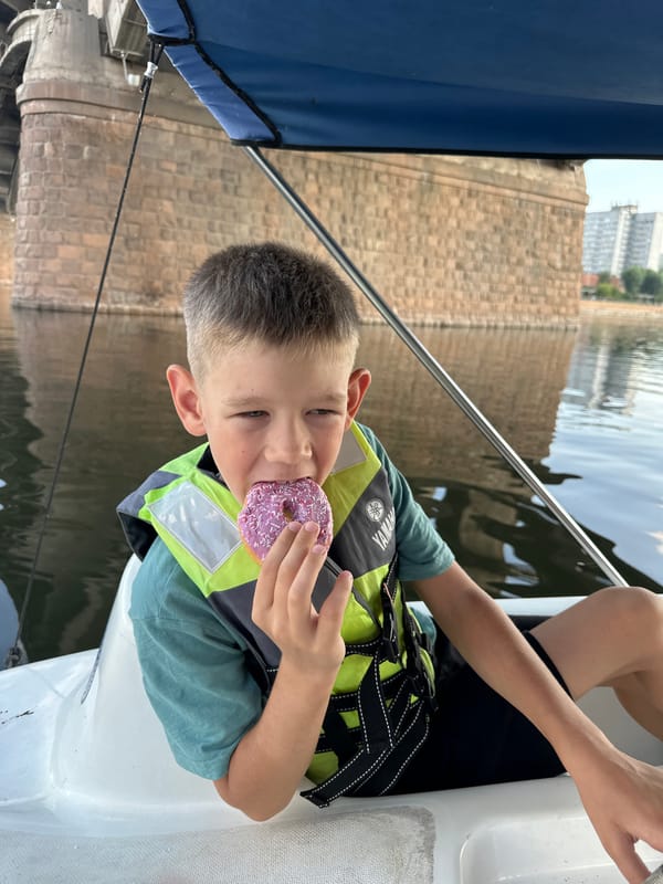 Paddleboat afternoon: donuts, a bridge, and calm water.