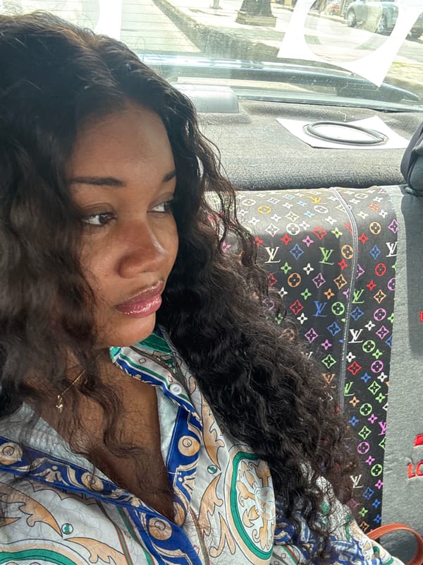 Woman rests in vehicle with designer pillow in Nigeria