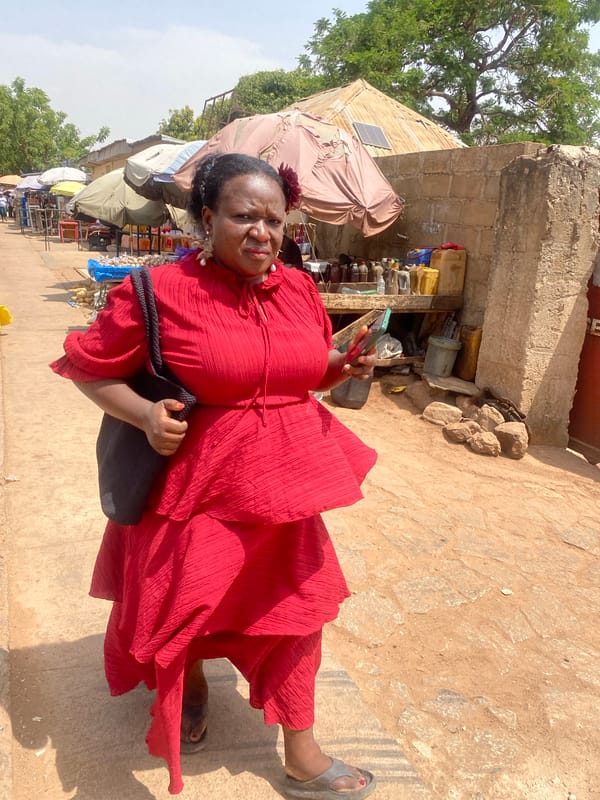 Woman walks stone path in Rido, Nigeria