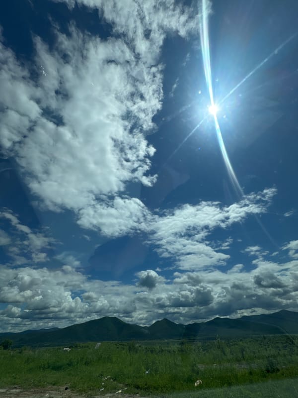 Sunny summer drive through green mountain terrain near Теплоозёрск