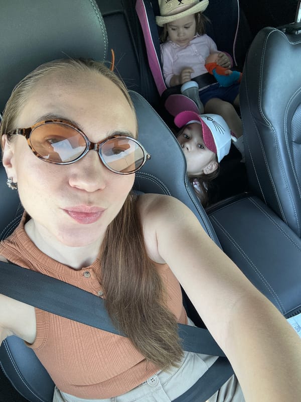 Woman takes car selfies with children in Kharnavy, Russia