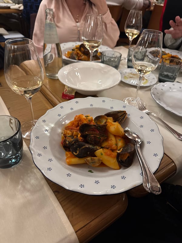 Seafood pasta dinner documented in Milan restaurant setting