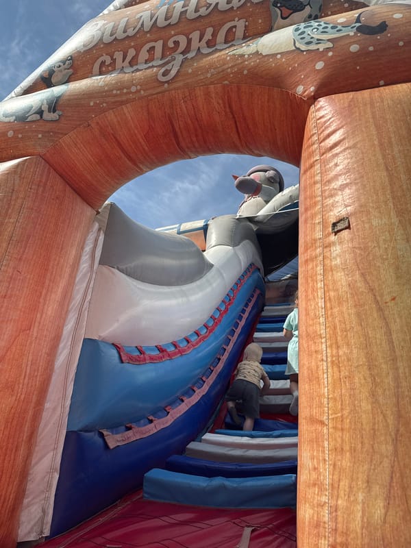 Children play at bounce house, ride scooters in Vereshchagino