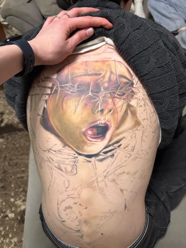 Tattoo session depicting portrait underway in Perm, Russia