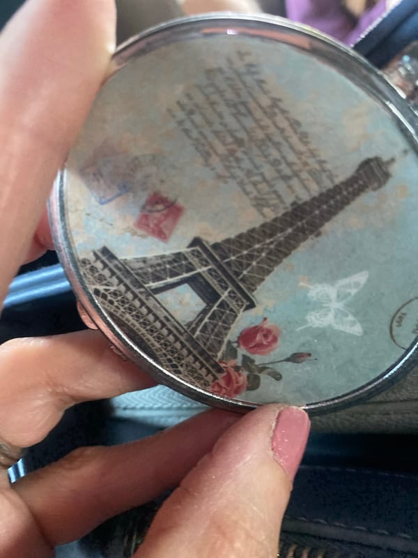 Person holds Eiffel Tower-designed compact mirror in Mexico City