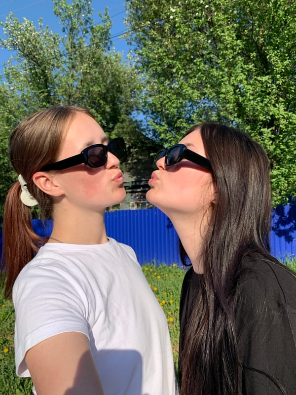 Two women take playful photos in Фоки Russia