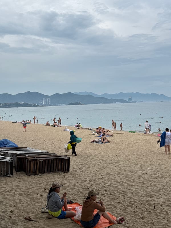 Crowded morning at Nha Trang beach, overcast skies, full shoreline