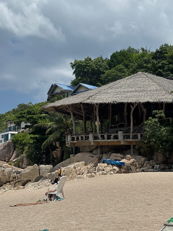 Relaxed day at a tropical beach with kayaks and swimmers