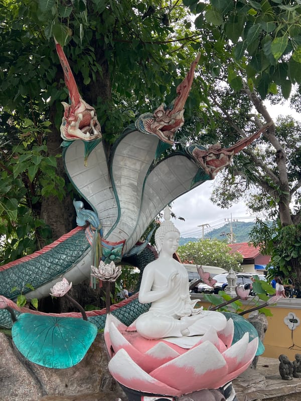 Ornate serpent deity and golden ceremonial float at Ko Samui temple