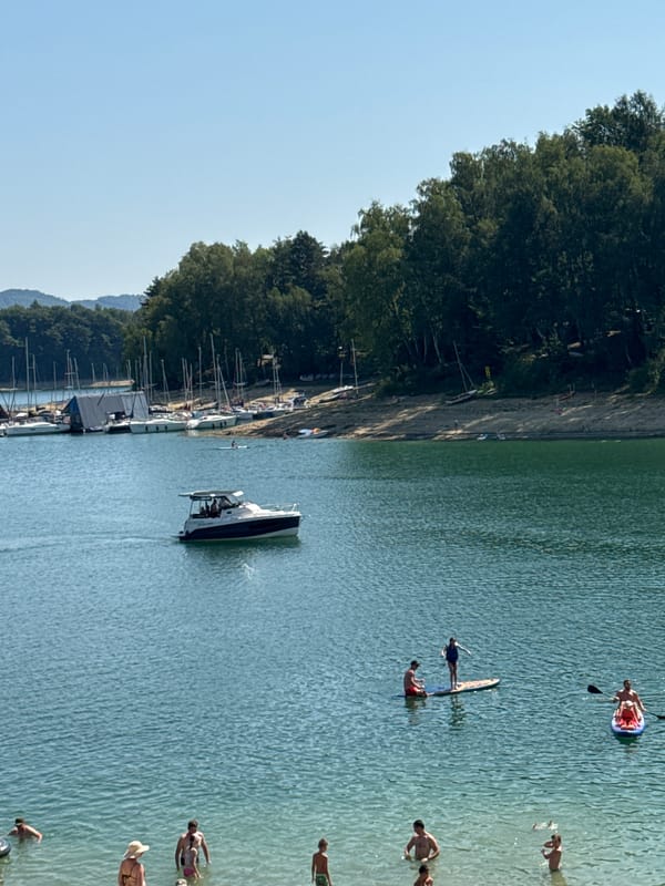 Summer crowds fill Lake Solina's beach and marina in Polańczyk