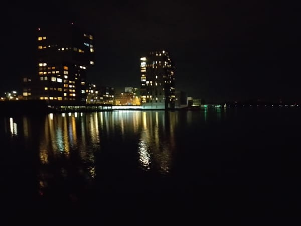 Nighttime building reflections captured in Almere waterway