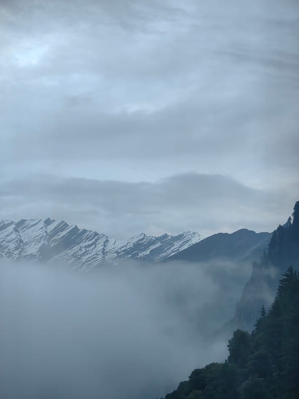 Foggy Himalayan peaks and hillside town, Vashisht