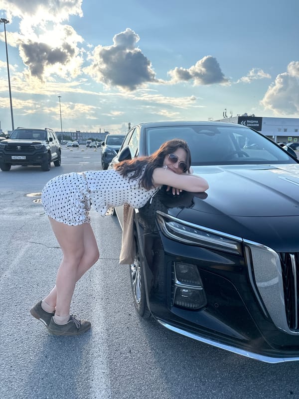 Casual parking lot photos with a black sedan, Russia