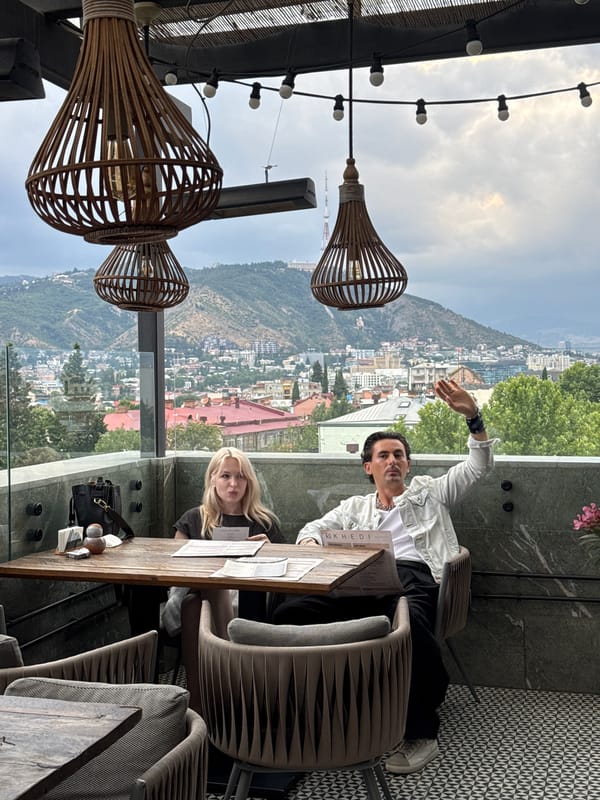 Tbilisi skyline views from a balcony, dramatic skies overhead