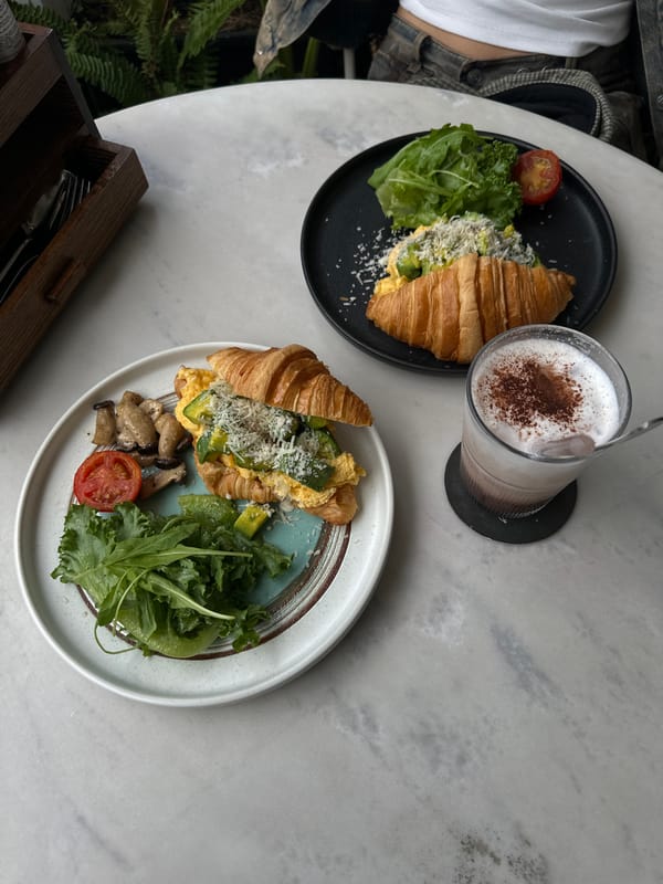 Croissant breakfast spread getting photographed at a Da Lat café