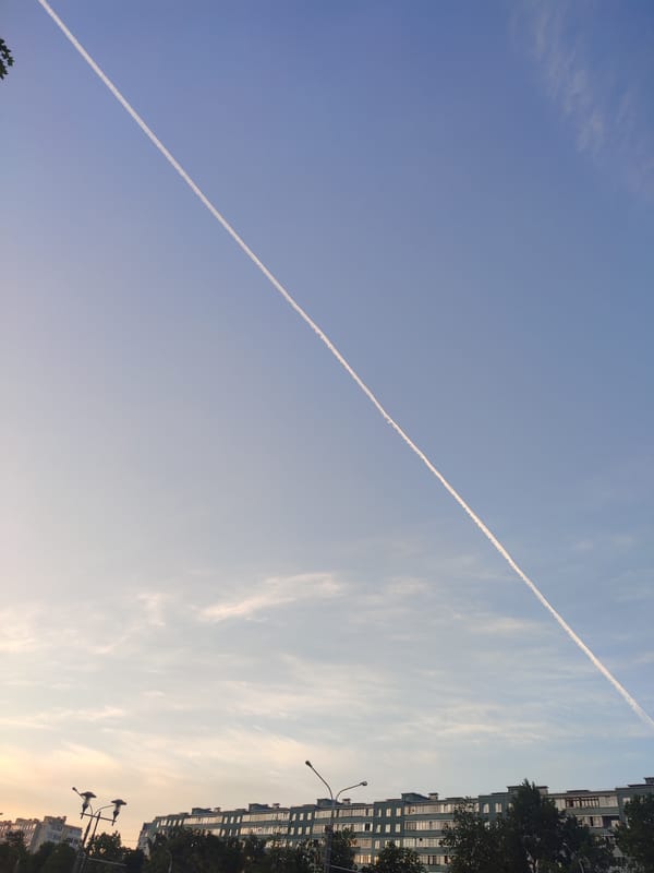 Aircraft contrail observed crossing sunset sky over Minsk