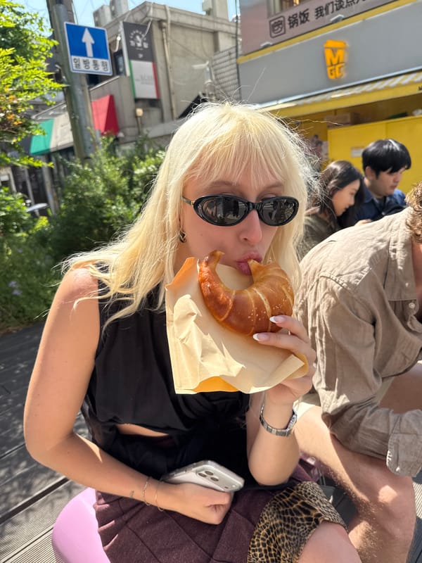 Seoul residents share branded pastries in sunny outdoor setting