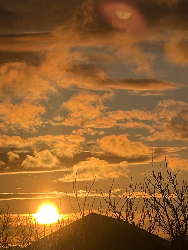 Sunset illuminates Riga skyline with orange clouds April 25