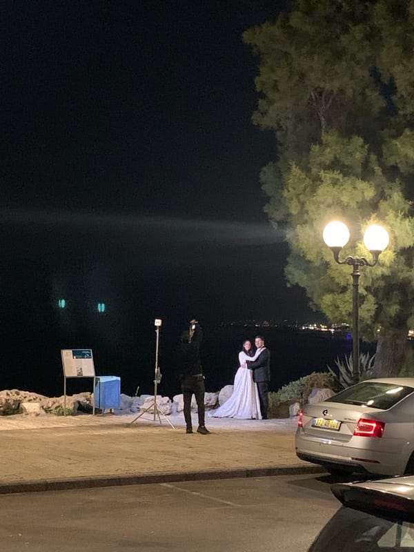Outdoor wedding ceremony held on illuminated Tel Aviv street