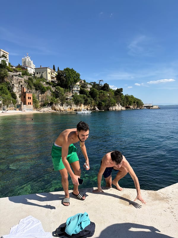 Two men relax on pier in sunny Rijeka