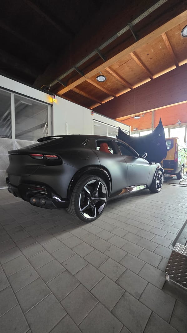 Luxury cars serviced at automotive facility, surrounding area documented