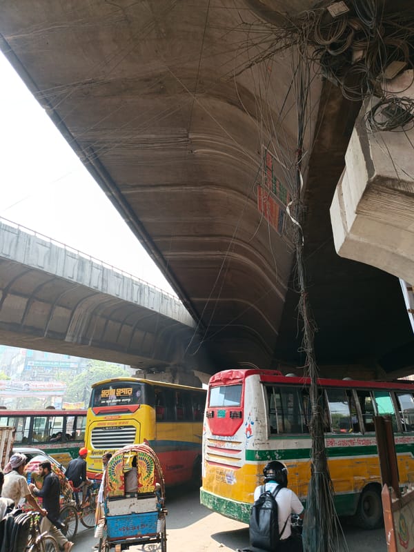 Morning street life captured under Dhaka overpass