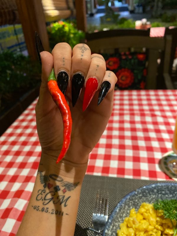 Tattooed diner enjoys meal with chili pepper in Vietnam
