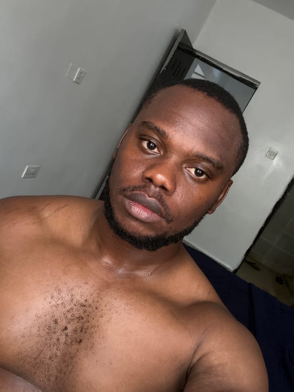 Man photographed in bedroom setting in Nigeria